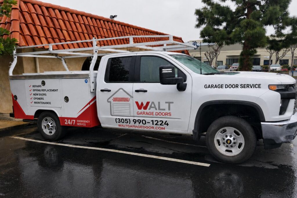 White WALT Garage Doors service truck parked outside a building